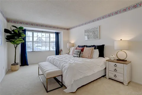 a bedroom with bed and window