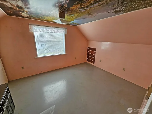 a view of living room with furniture and mirror