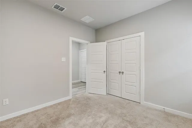 an empty room with white cabinet