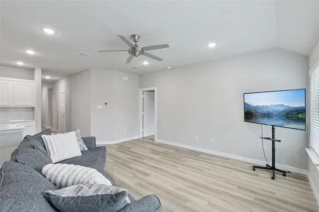 a spacious bedroom with a bed and a chandelier