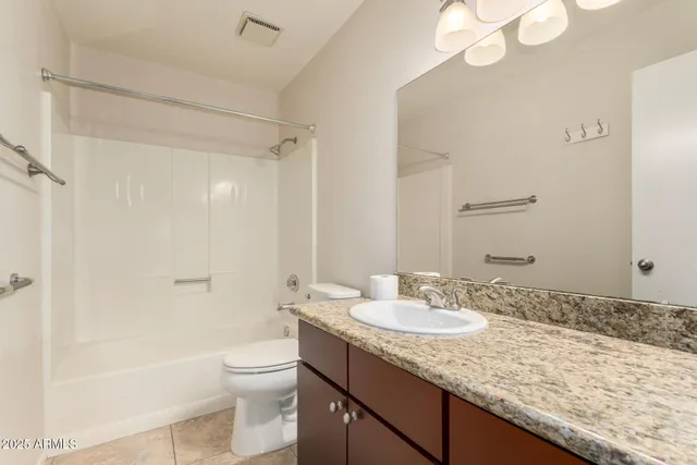 an empty room with fan and glass door