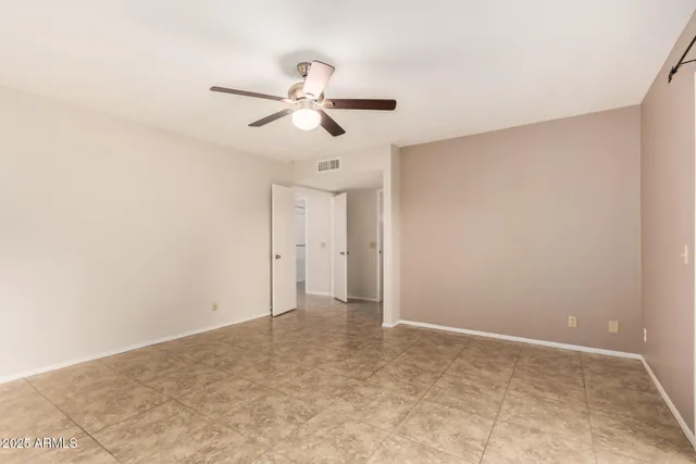 a bathroom with a granite countertop sink a toilet and a mirror