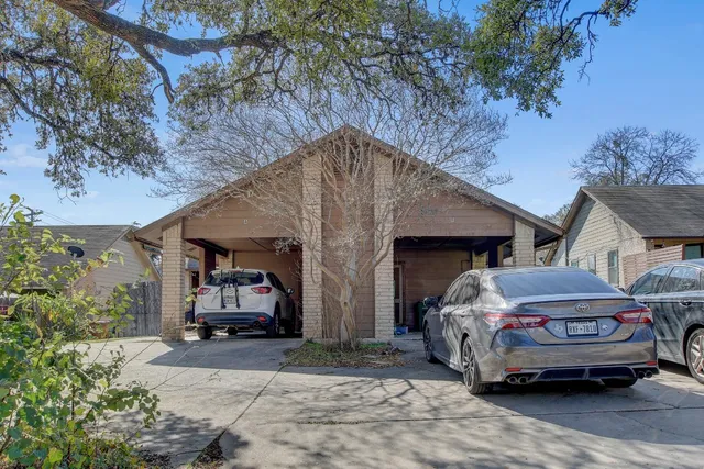 a front view of house with car parked