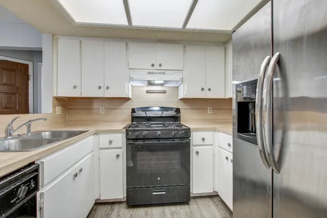 a kitchen with a stove sink and refrigerator