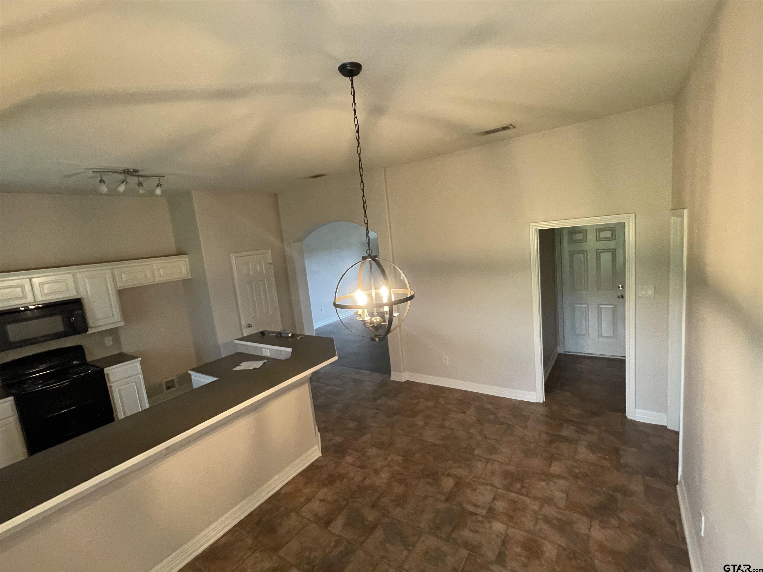 213 Cass Circle Tyler, TX 75703 - Photo 11 of 44 a kitchen with stainless steel appliances granite countertop a sink a stove and a refrigerator