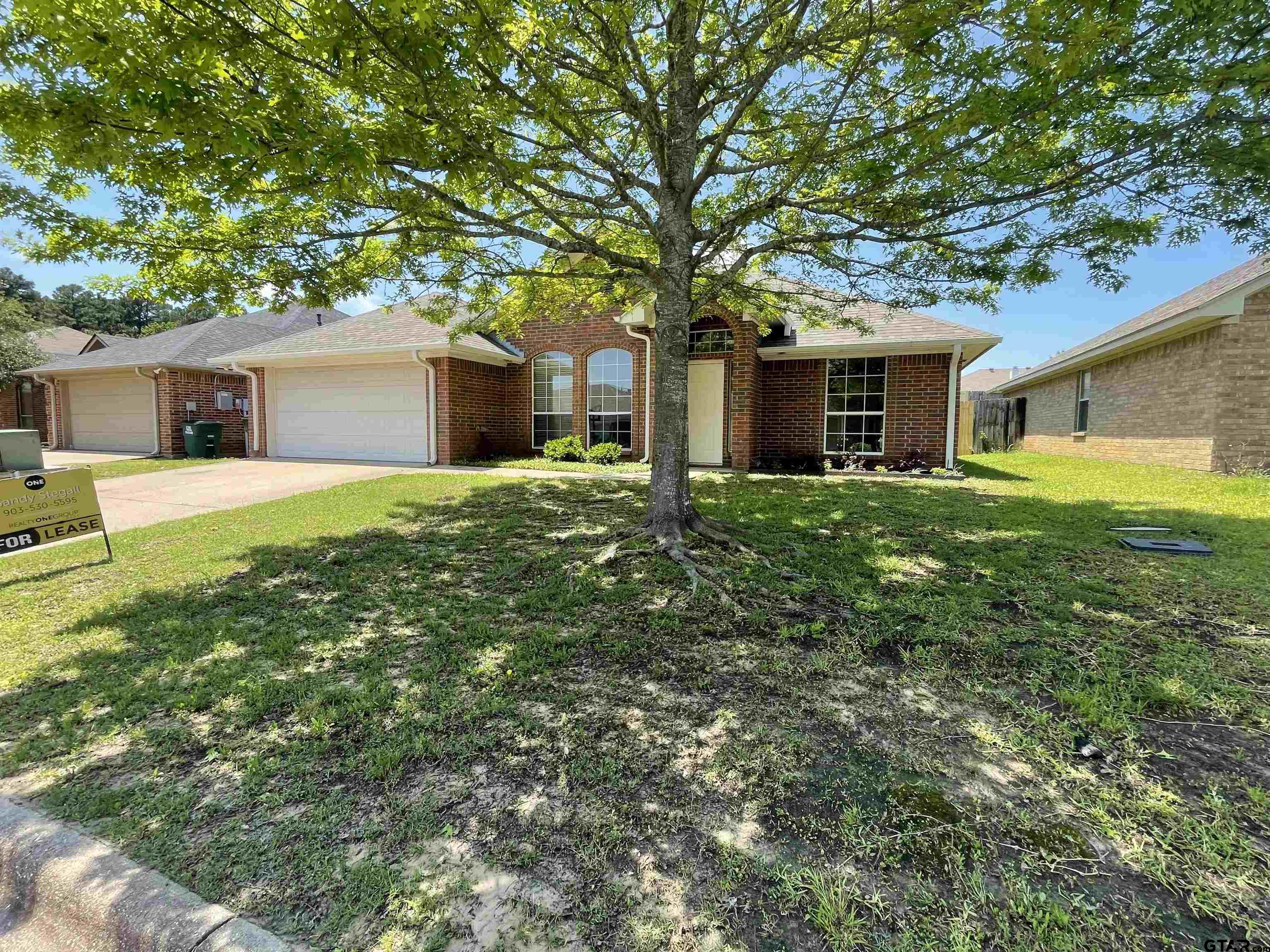 213 Cass Circle Tyler, TX 75703 - Photo 16 of 44 a front view of house with yard and trees