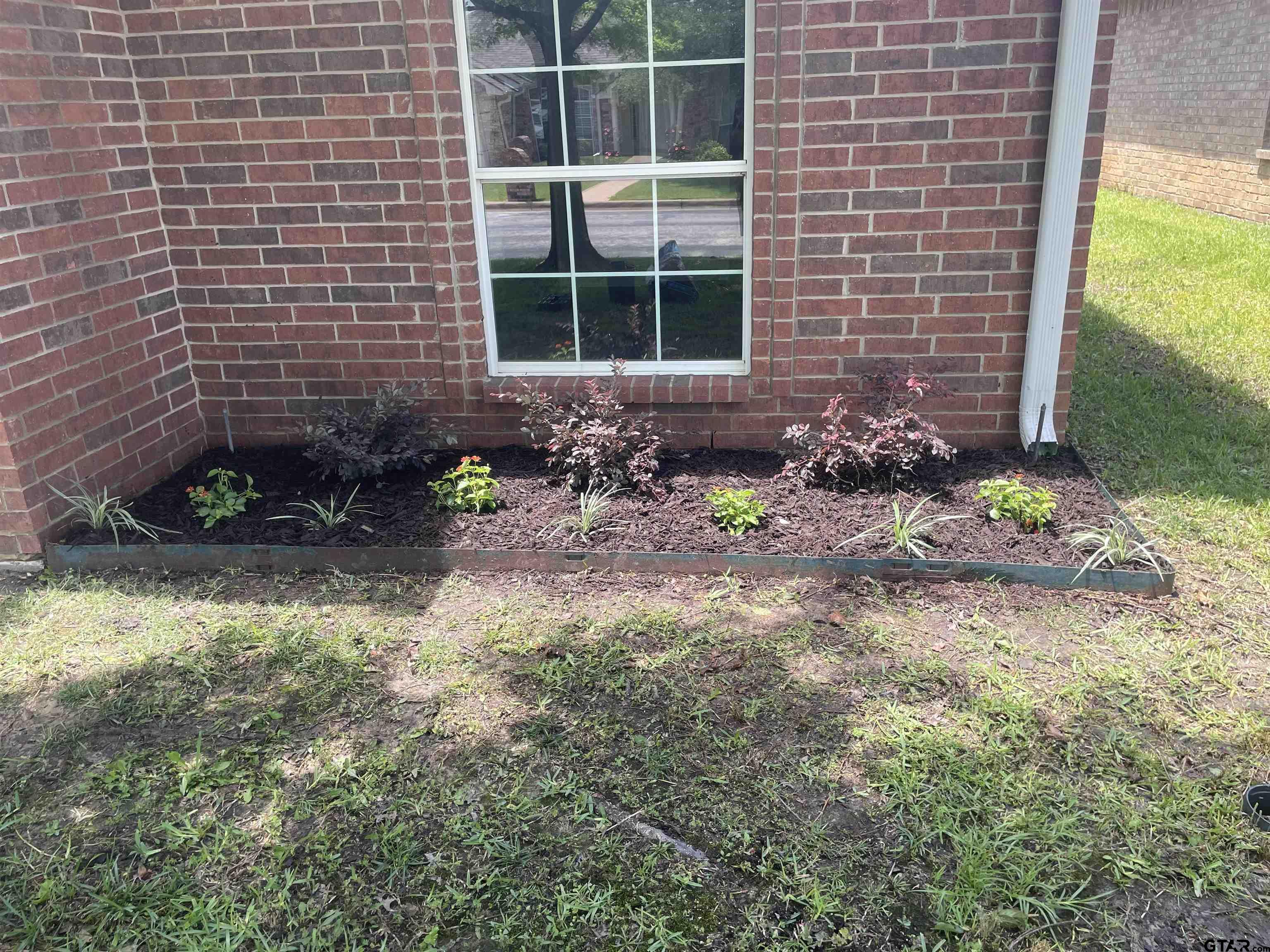 213 Cass Circle Tyler, TX 75703 - Photo 17 of 44 a view of house with a backyard and a garden