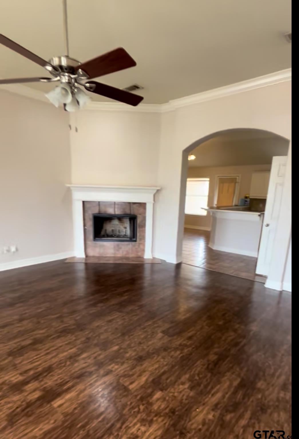 213 Cass Circle Tyler, TX 75703 - Photo 20 of 44 an empty room with wooden floor fireplace and windows