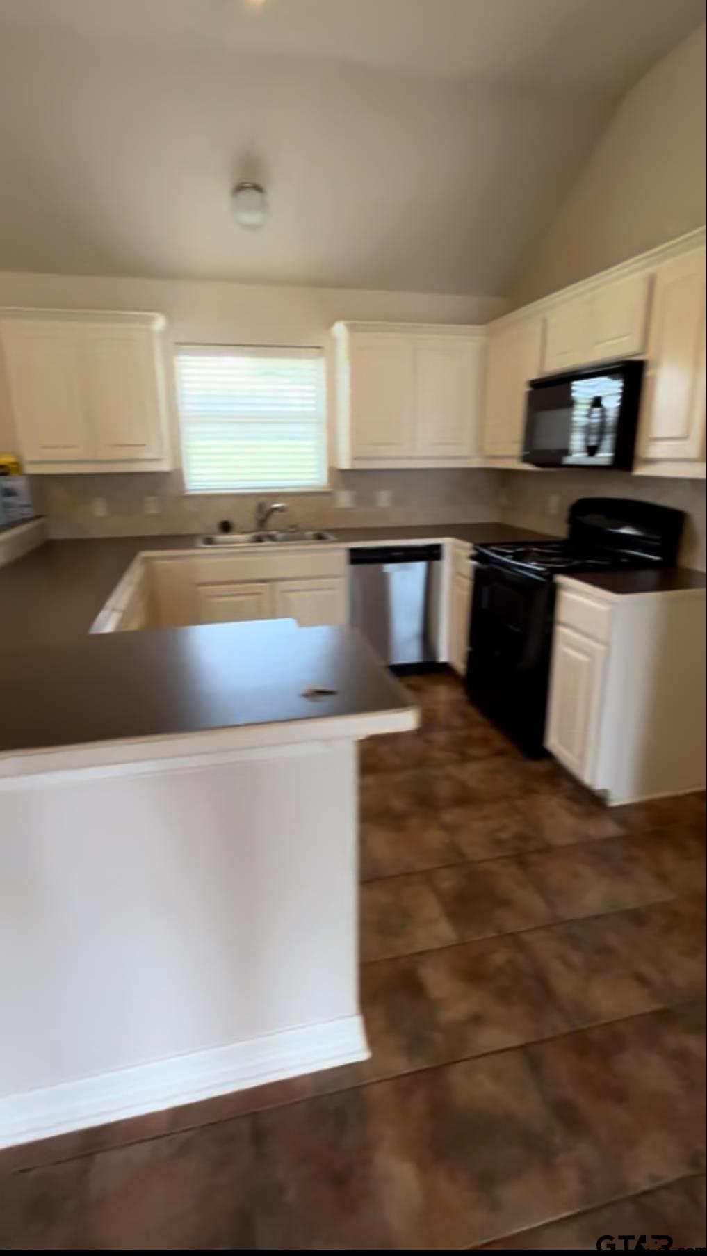 213 Cass Circle Tyler, TX 75703 - Photo 29 of 44 a kitchen with stainless steel appliances wooden cabinets and a counter top