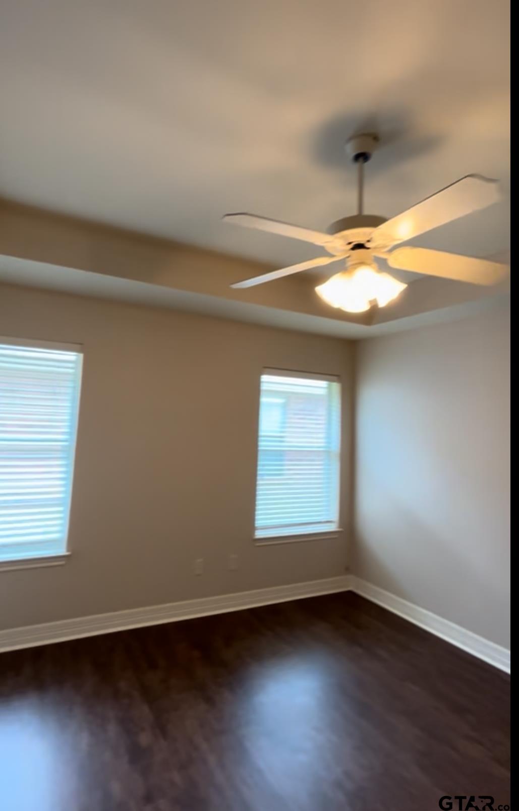 213 Cass Circle Tyler, TX 75703 - Photo 33 of 44 an empty room with wooden floor and chandelier
