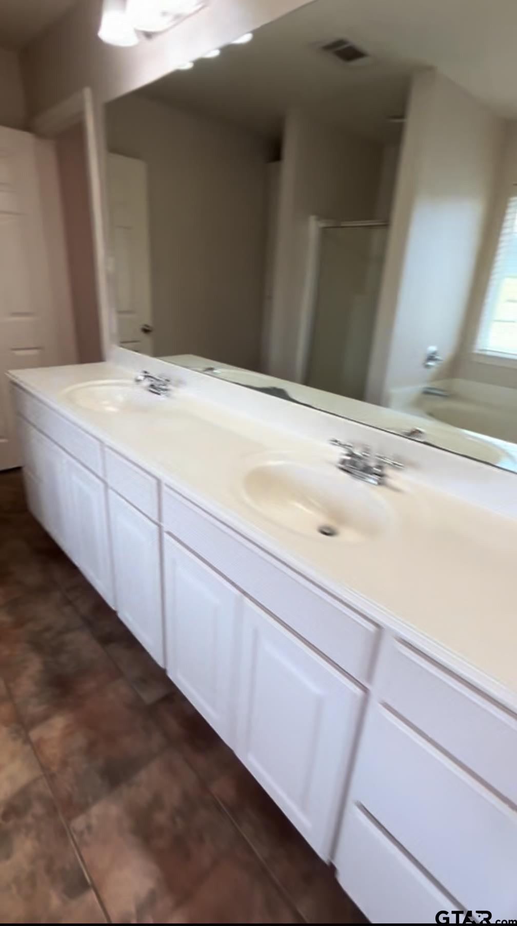 213 Cass Circle Tyler, TX 75703 - Photo 40 of 44 a bathroom with a sink and a mirror