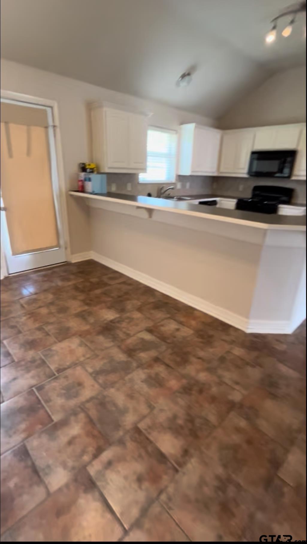213 Cass Circle Tyler, TX 75703 - Photo 42 of 44 a kitchen with stainless steel appliances a sink a stove a microwave and cabinets