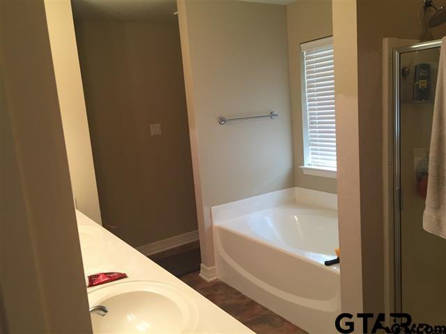 213 Cass Circle Tyler, TX 75703 - Photo 6 of 44 a bathroom with a tub and sink