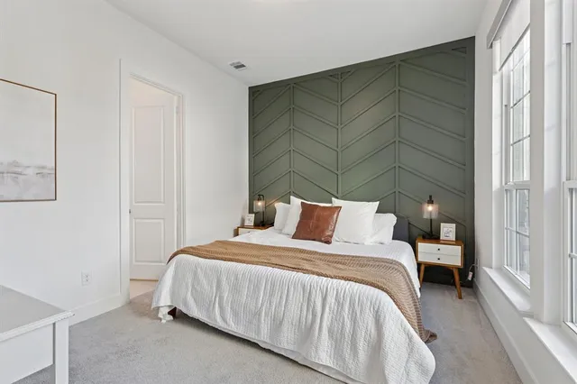 a bedroom with a bed and a window