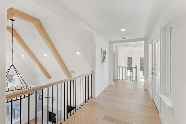 a view of a hallway with wooden floor and entryway