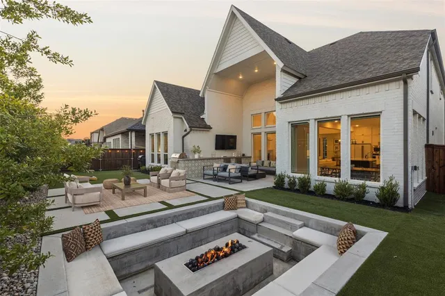 a view of a house with backyard sitting area and garden