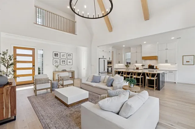 a living room with furniture a rug and kitchen view