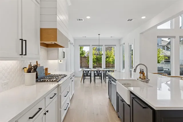 a kitchen with counter top space a sink cabinets and appliances