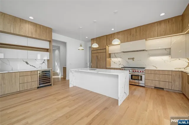 a kitchen with stainless steel appliances a stove and cabinets