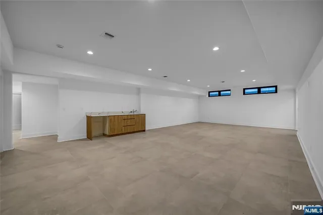 a view of an empty room with a ceiling fan