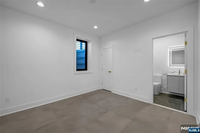 an empty room with a bathroom and a sink
