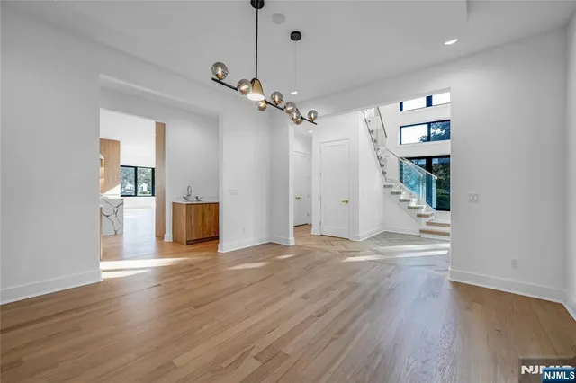 a view of a kitchen with wooden floor and a ceiling fan