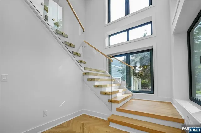 a view of entryway and hall with wooden floor