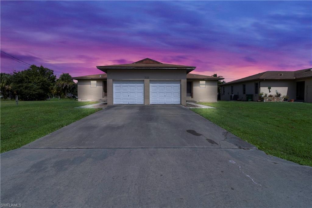 a front view of a house with a yard and garage