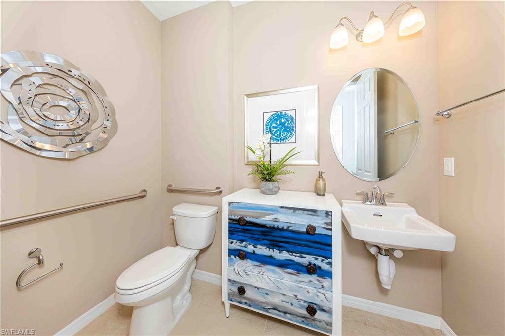 882 Enbrook Loop Naples, FL 34114 - Photo 11 of 19 a bathroom with a sink and a mirror
