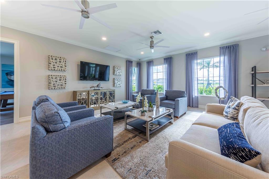 882 Enbrook Loop Naples, FL 34114 - Photo 15 of 19 a living room with furniture and a flat screen tv
