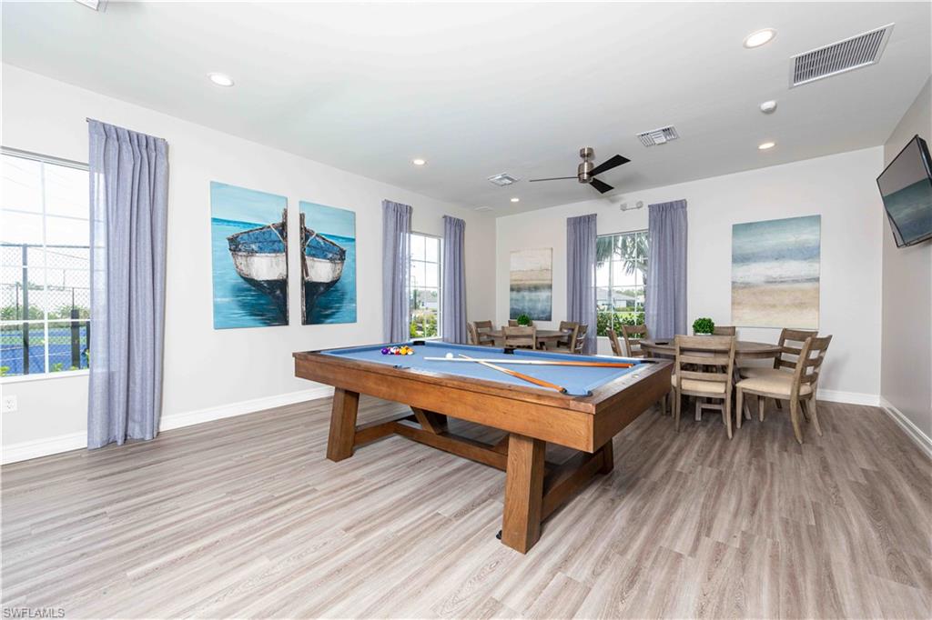 882 Enbrook Loop Naples, FL 34114 - Photo 17 of 19 a room with furniture pool table wooden floor and windows