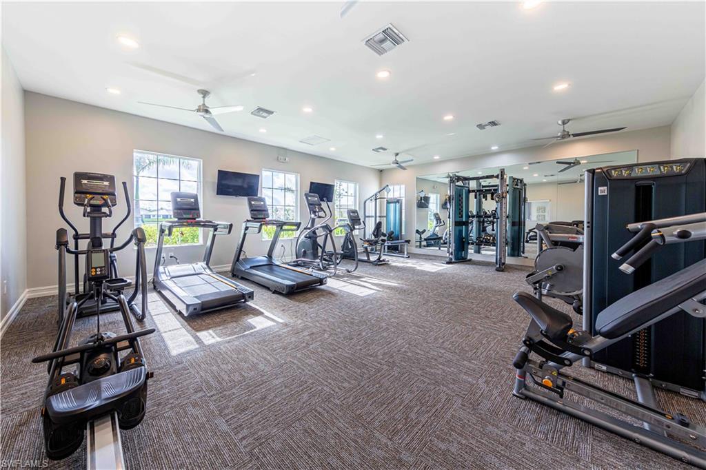 882 Enbrook Loop Naples, FL 34114 - Photo 18 of 19 a view of a room with gym equipment