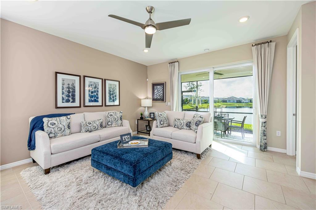 882 Enbrook Loop Naples, FL 34114 - Photo 6 of 19 a living room with furniture and a large window