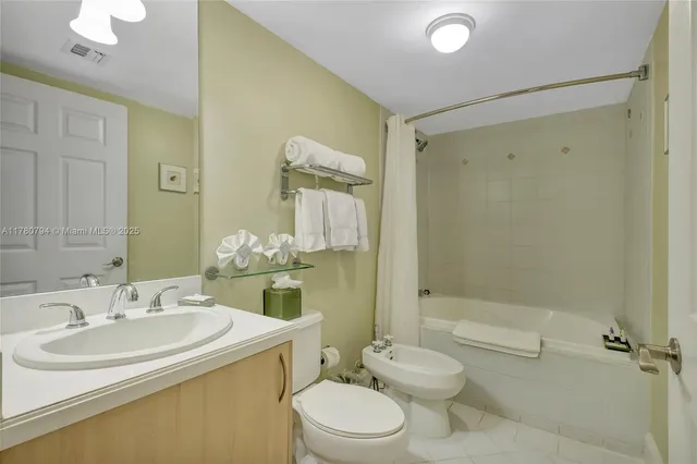 a bathroom with a sink toilet tub and shower