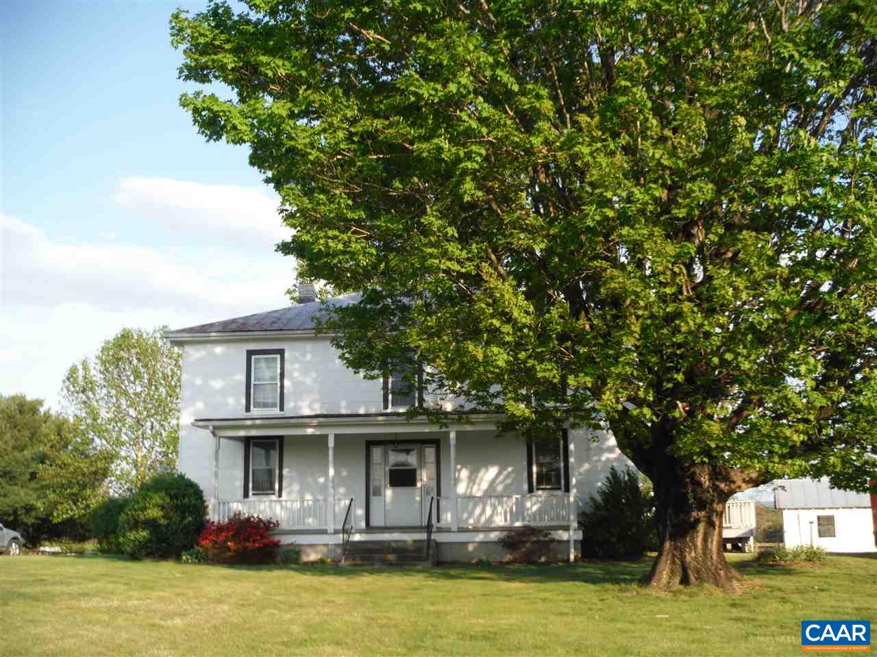 a front view of house with yard green space and lake view