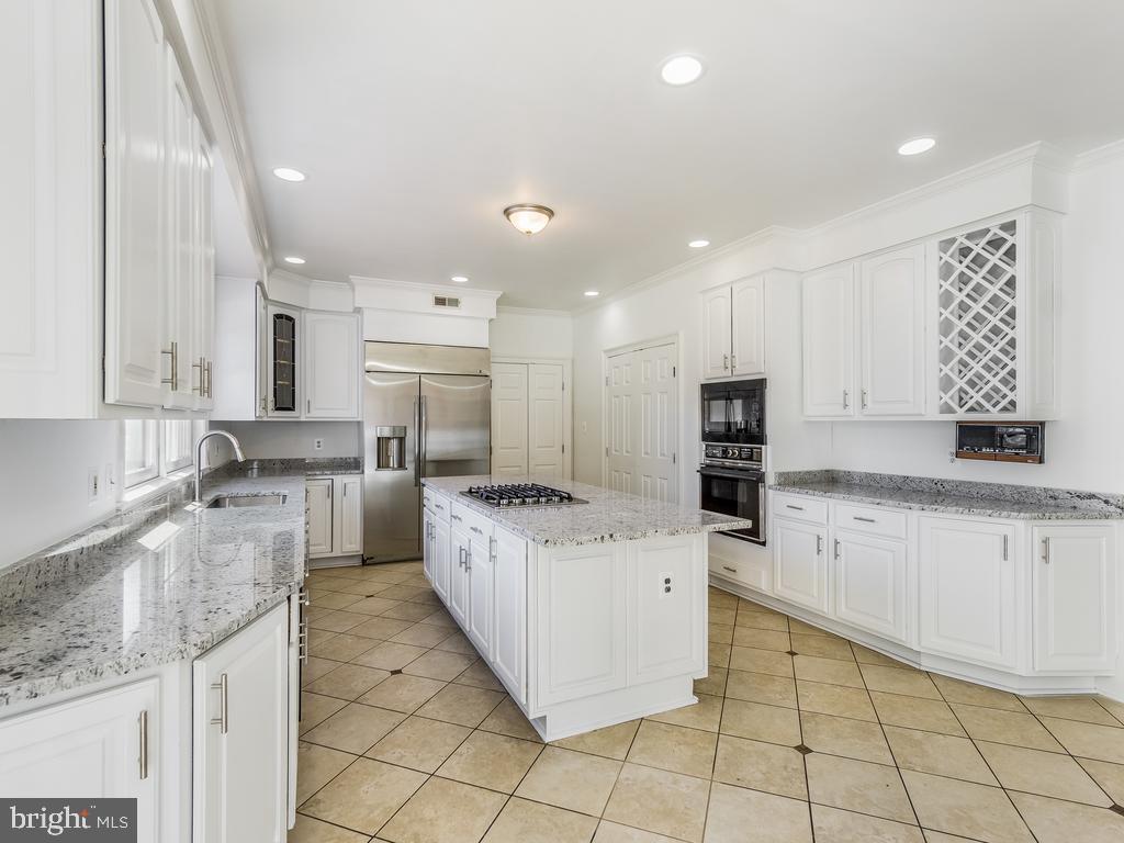 8951 Brook Road McLean, VA 22102 - Photo 13 of 32 a open kitchen with granite countertop a sink and cabinets