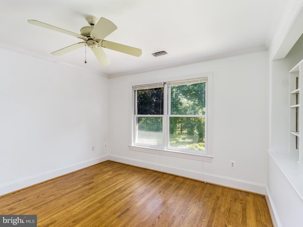 8951 Brook Road McLean, VA 22102 - Photo 14 of 32 an empty room with a window and a ceiling fan