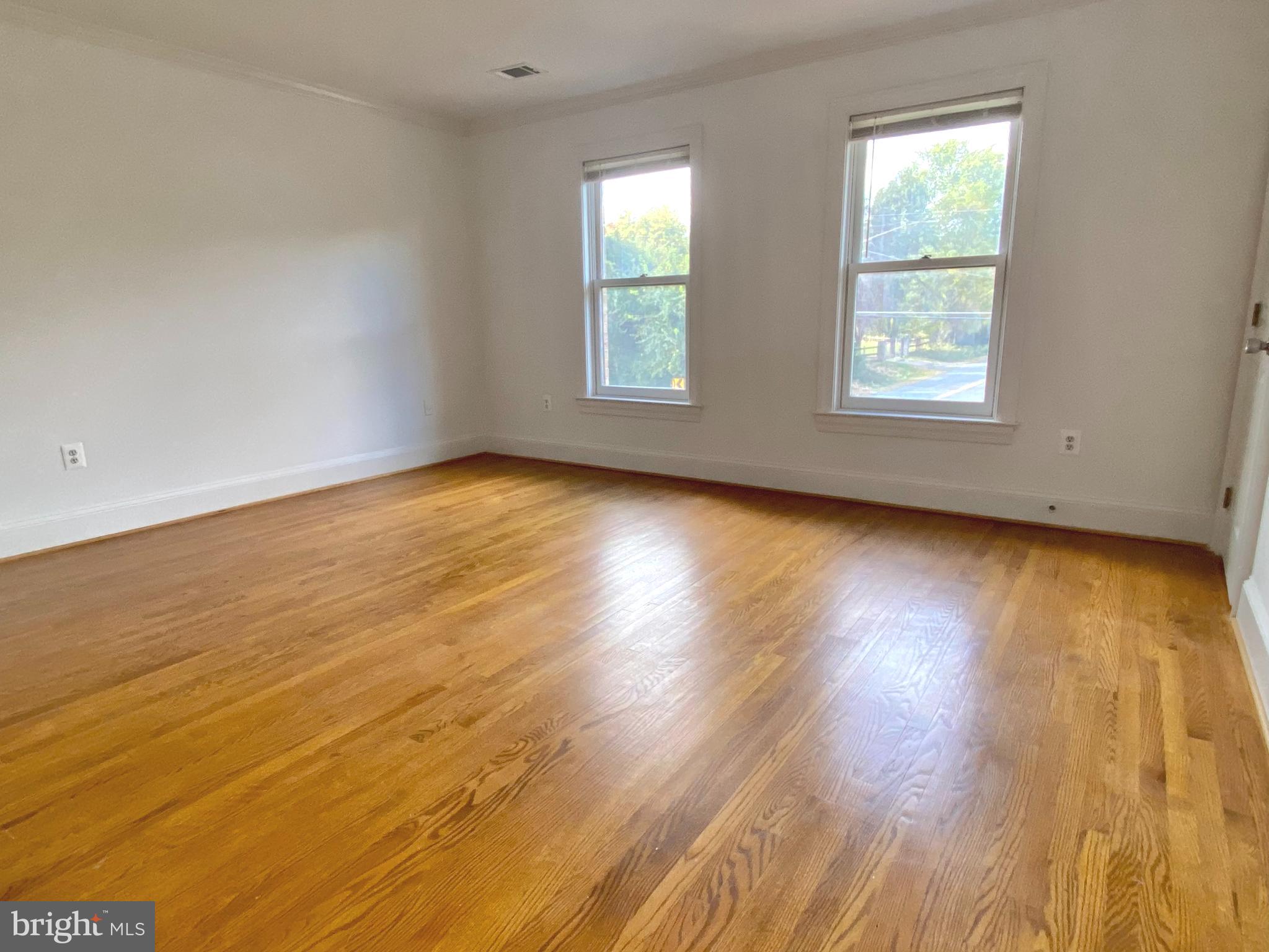 8951 Brook Road McLean, VA 22102 - Photo 19 of 32 an empty room with wooden floor and windows