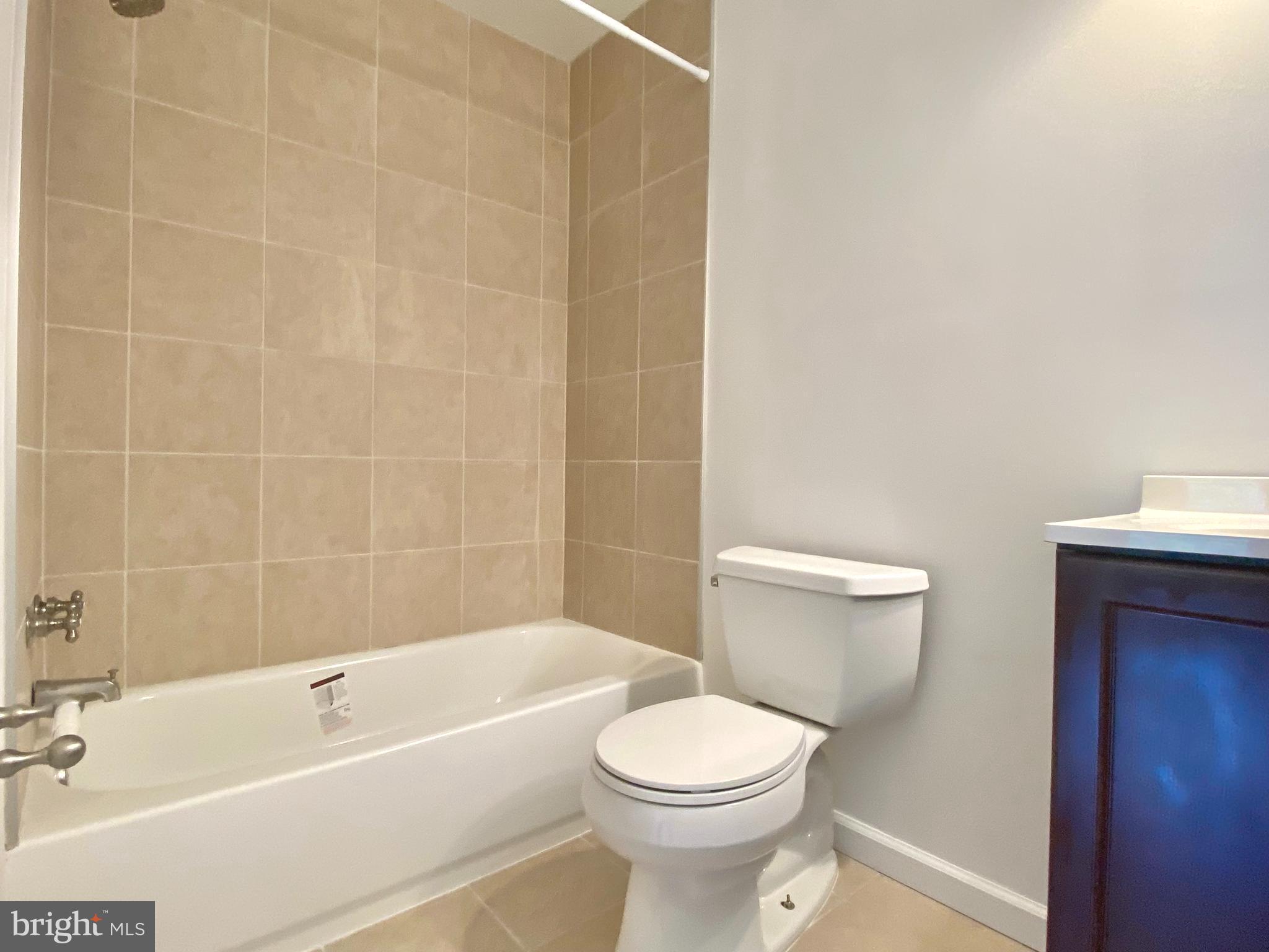 8951 Brook Road McLean, VA 22102 - Photo 20 of 32 a white toilet and tub sitting next to a bathroom sink