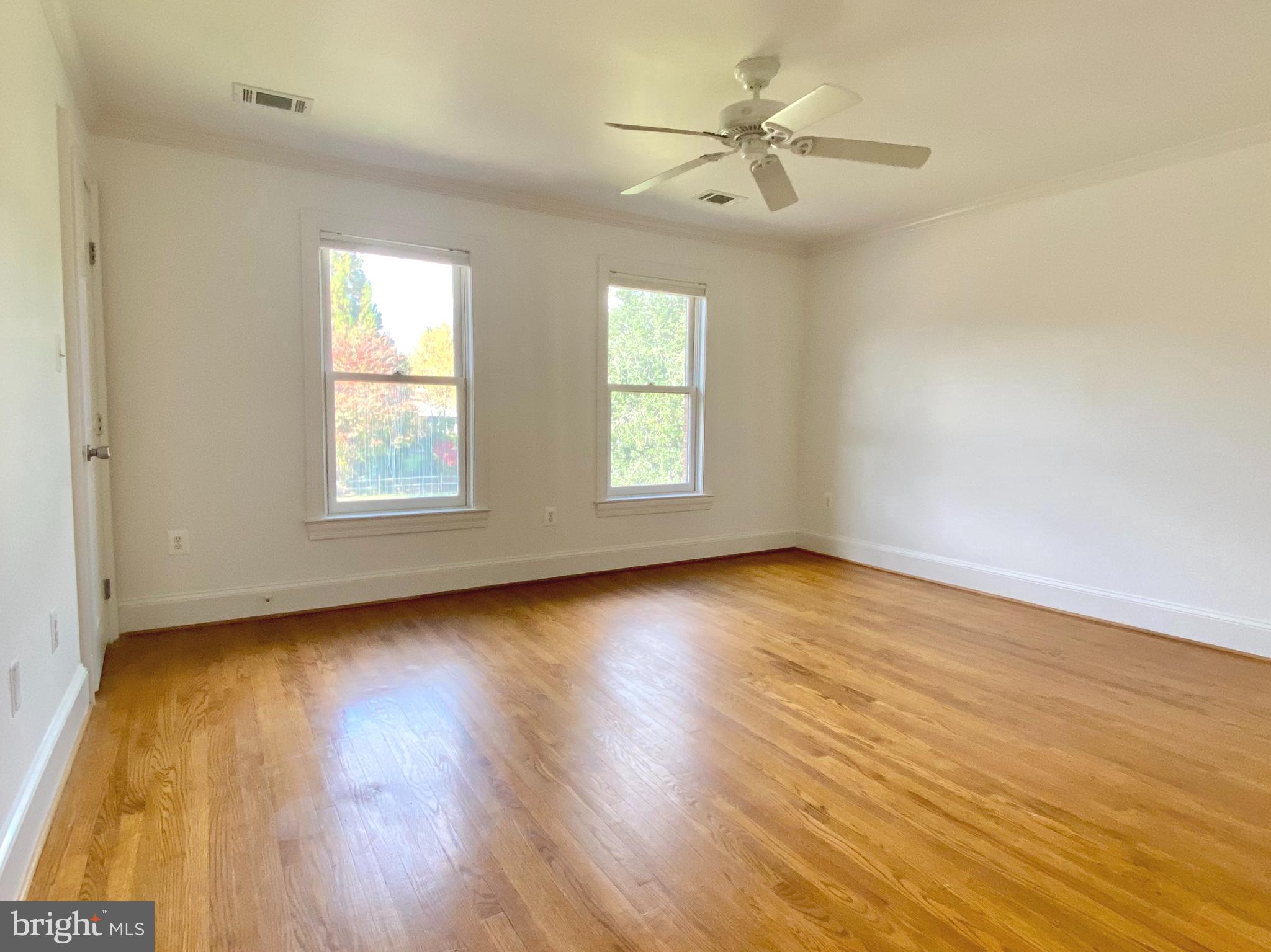 8951 Brook Road McLean, VA 22102 - Photo 21 of 32 an empty room with wooden floor and windows