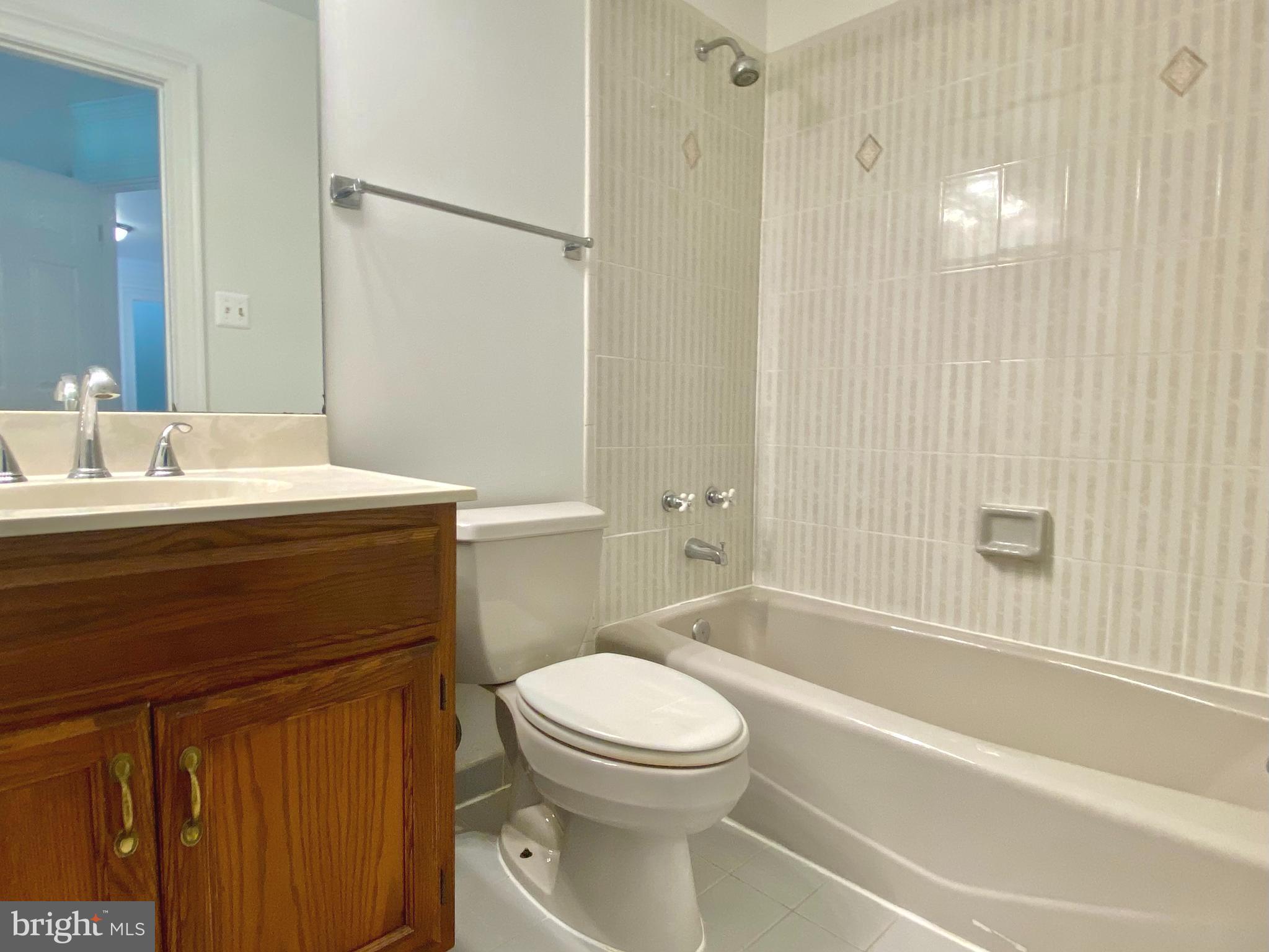 8951 Brook Road McLean, VA 22102 - Photo 22 of 32 a bathroom with a sink a toilet and shower