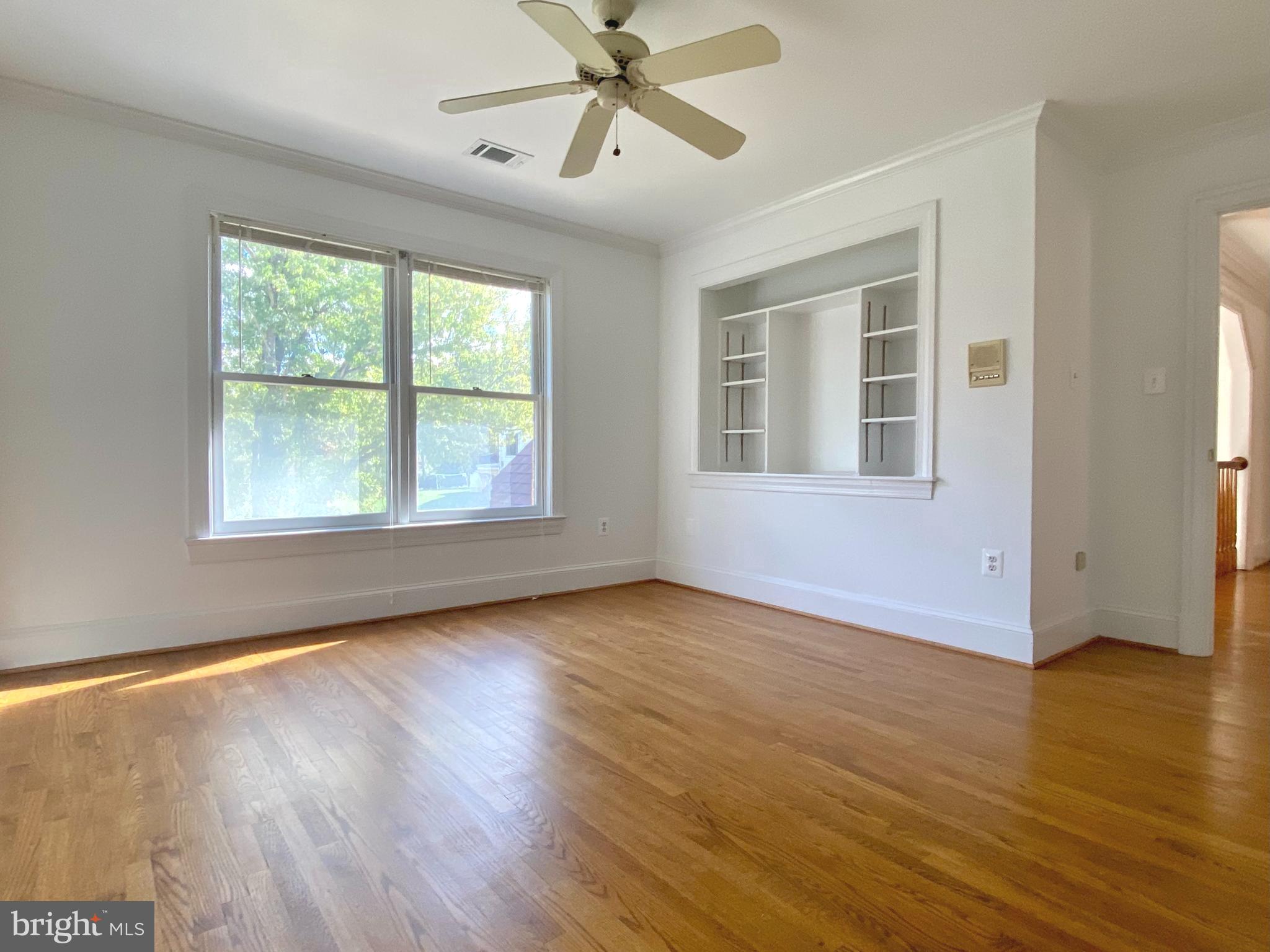 8951 Brook Road McLean, VA 22102 - Photo 23 of 32 a view of an empty room with wooden floor and a window