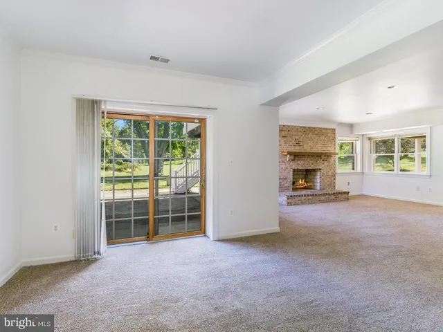 a view of empty room with a fireplace