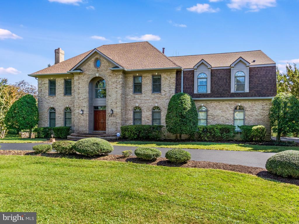 8951 Brook Road McLean, VA 22102 - Photo 28 of 32 a front view of a house with a yard