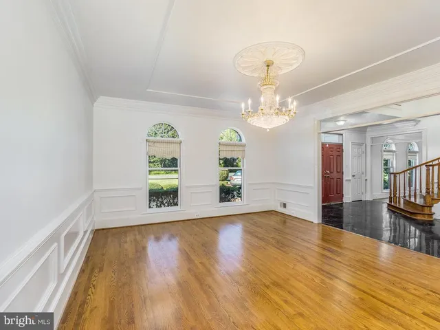 a view of a livingroom with wooden floor and a large window
