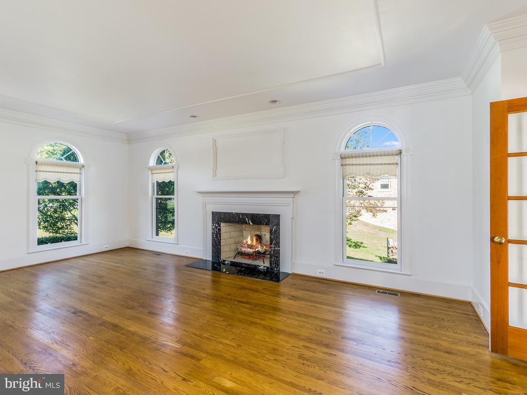 8951 Brook Road McLean, VA 22102 - Photo 7 of 32 an empty room with windows and fireplace
