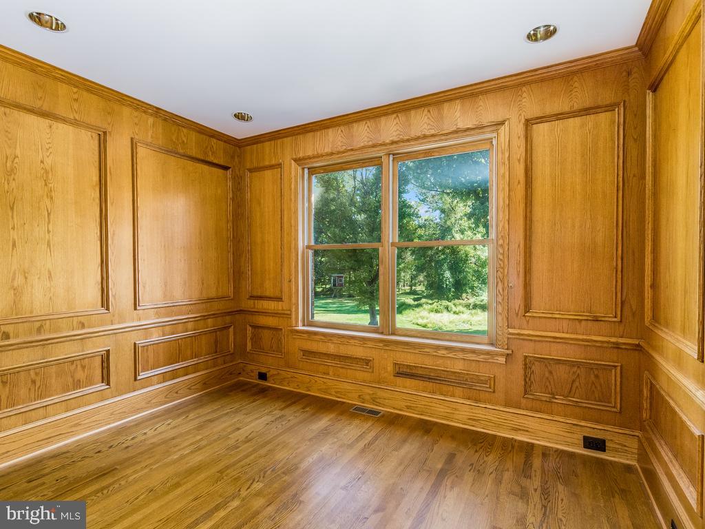8951 Brook Road McLean, VA 22102 - Photo 8 of 32 a view of an empty room with a window and wooden floor