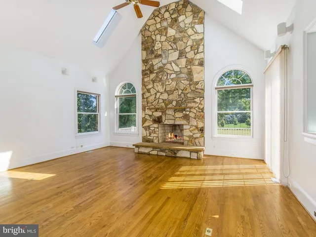 a view of an empty room with a window and a bathroom