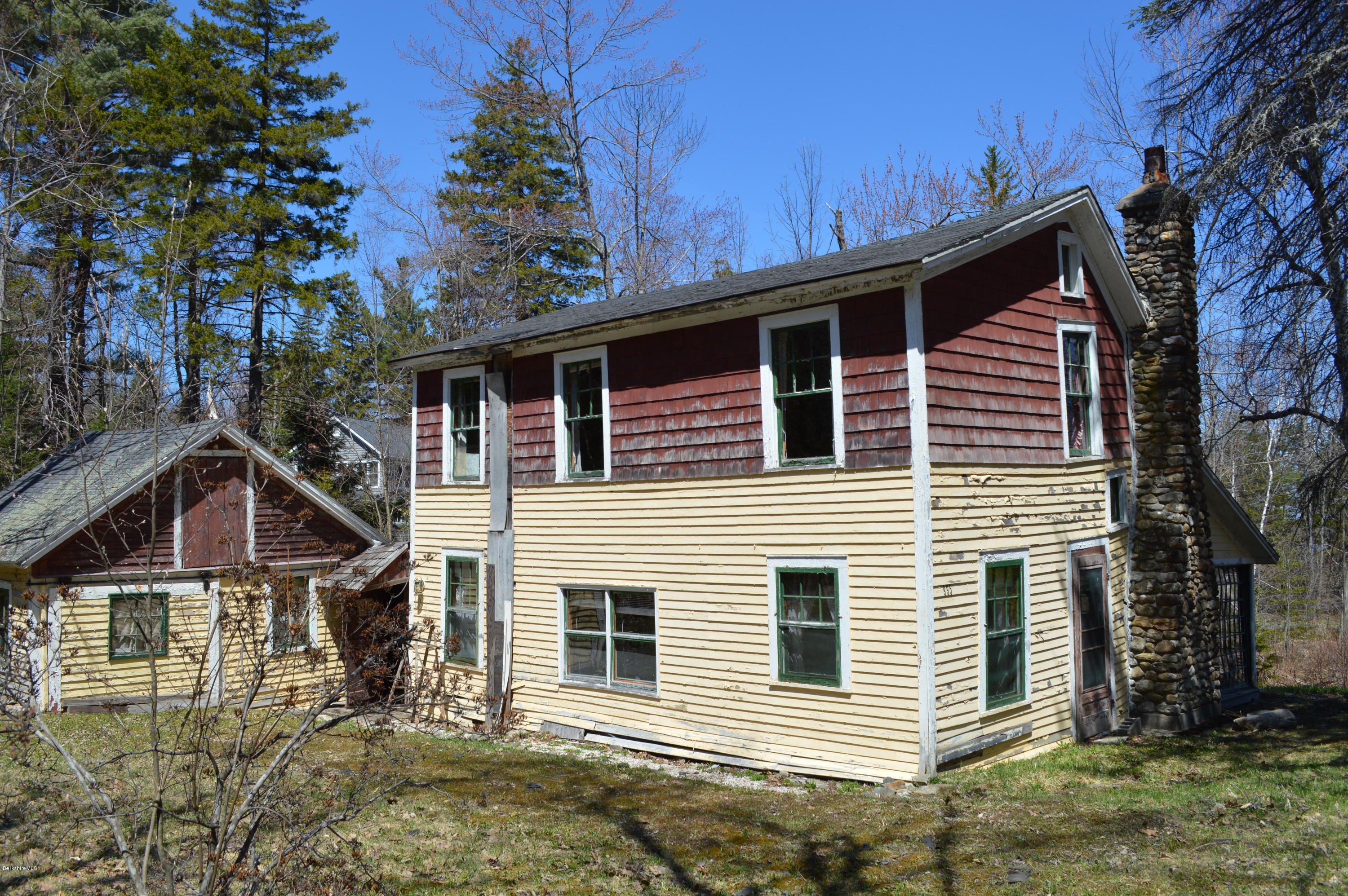995 Plumb Road Becket, MA 01223 - Photo 1 of 12 a front view of a house with garden