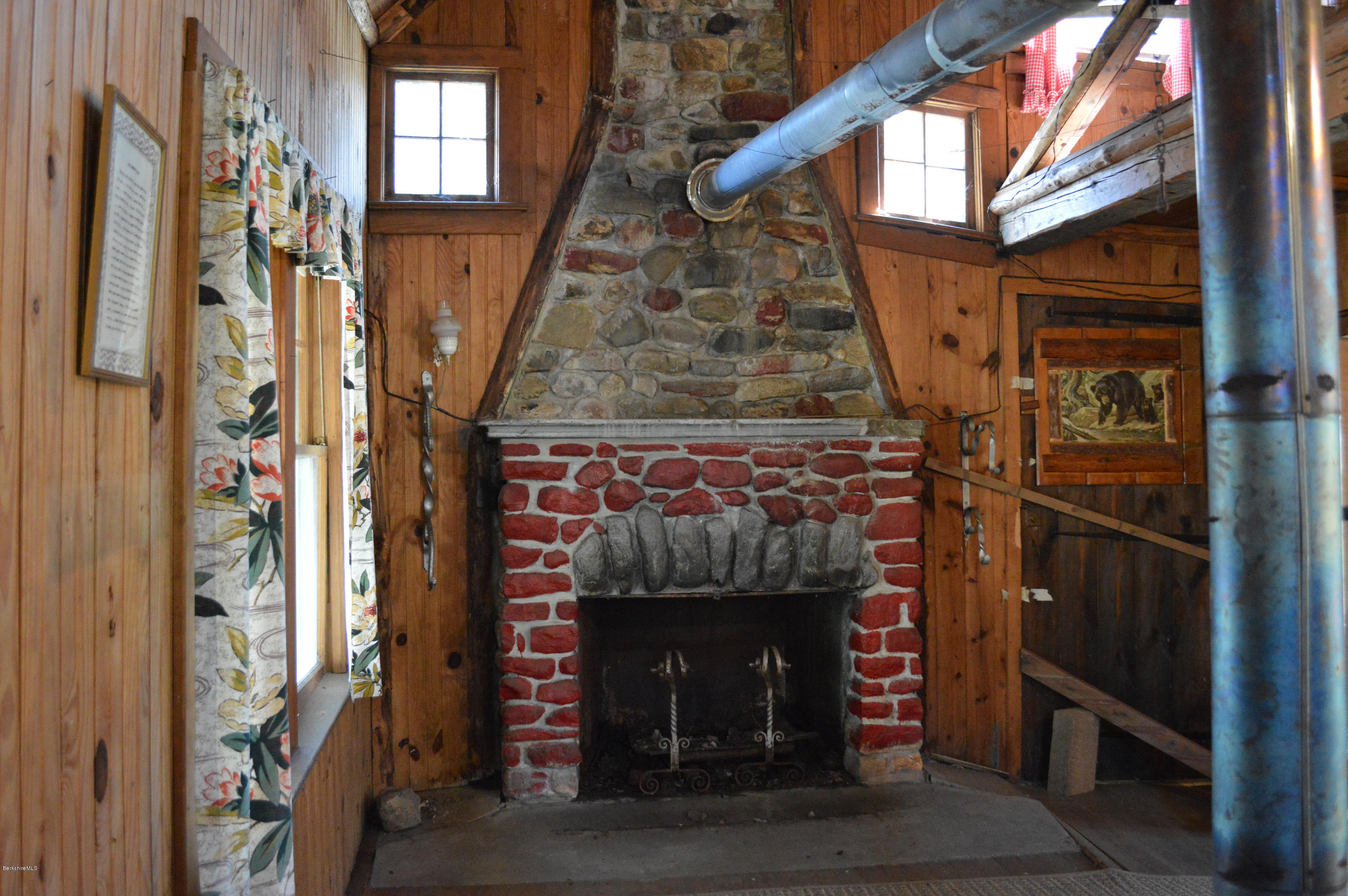 995 Plumb Road Becket, MA 01223 - Photo 2 of 12 a front view of a house with a door